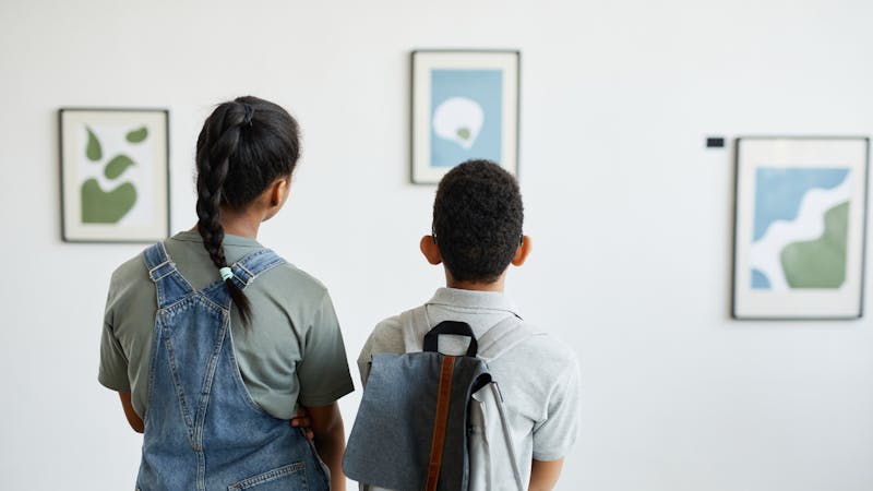 two kids at an art gallery 